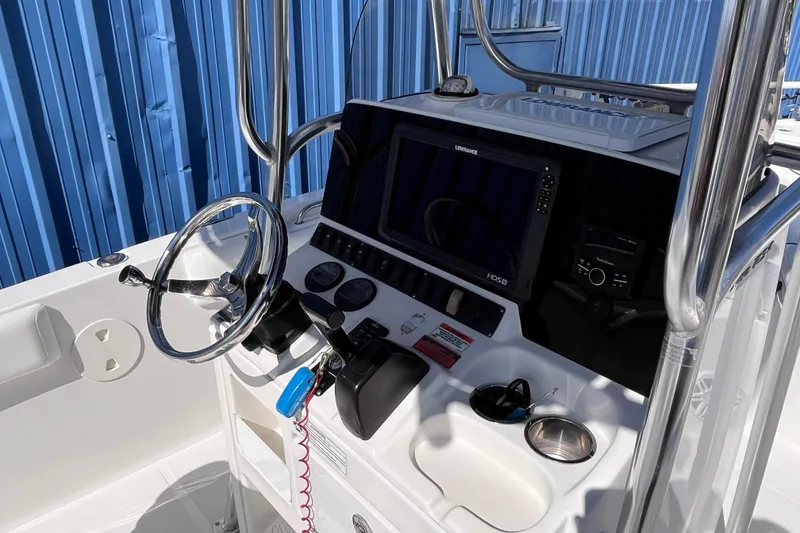 Slide: The Image of 2015 Sea Hunt Ultra 234 boat console with steering wheel and navigation system. - 8