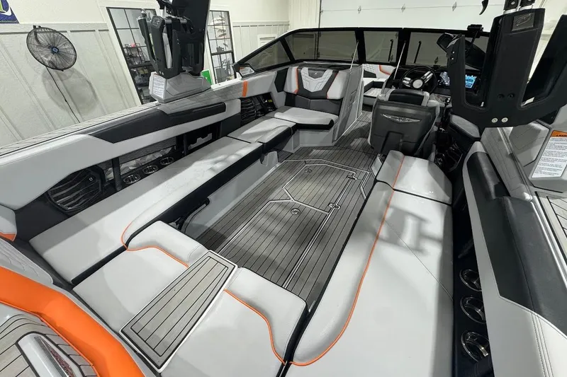 Slide: The Image of 2022 Nautique Super Air Nautique G25 boat seat with cup holders and sleek design. - 11