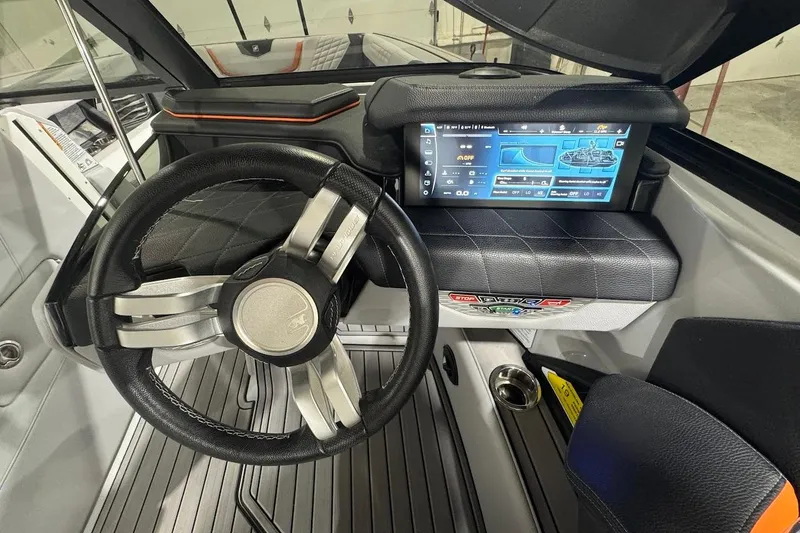 Slide: The Image of 2022 Nautique Super Air Nautique G25 boat on trailer in showroom. - 18