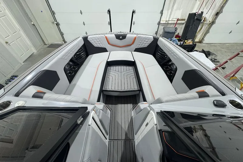 Slide: The Image of 2022 Nautique Super Air Nautique G25 boat on trailer in showroom. - 19