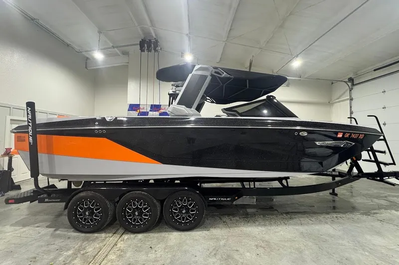 Slide: The Image of 2022 Nautique Super Air Nautique G25 interior seating with modern design and cup holders. - 6