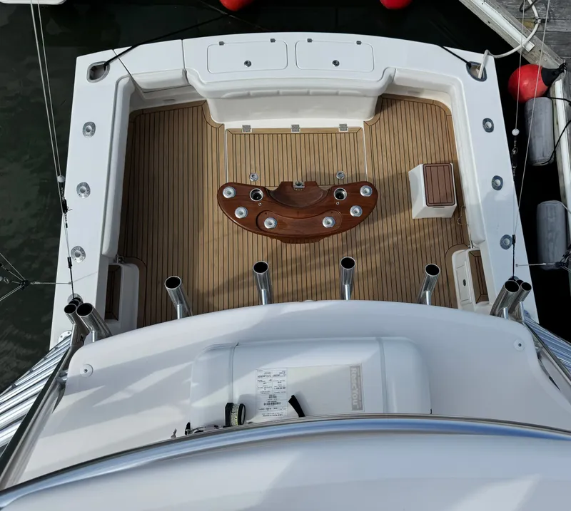 Slide: The Image of 2021 Albemarle 41 Express boat deck with teak flooring and fishing rod holders. - 10