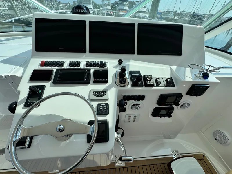 Slide: The Image of Control panel of 2021 Albemarle 41 Express boat with steering wheel and navigation screens. - 12