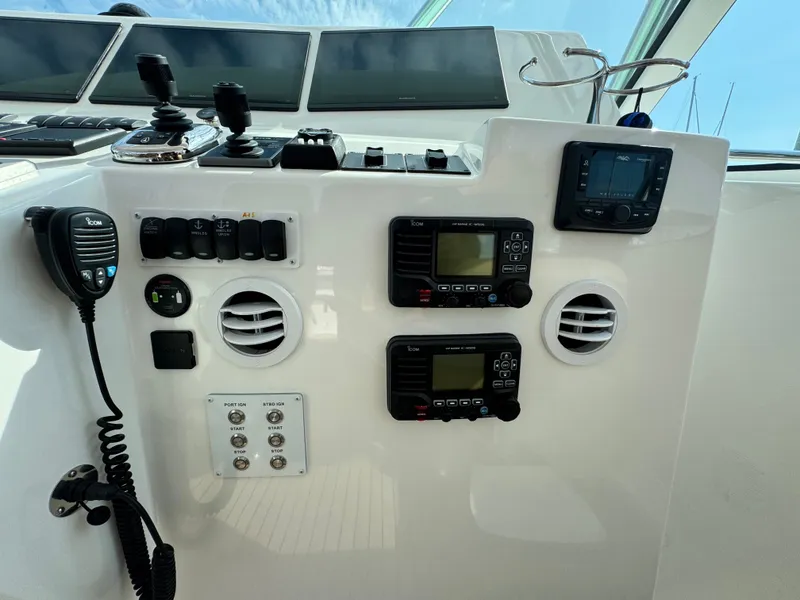 Slide: The Image of Control panel of 2021 Albemarle 41 Express boat with communication devices and switches. - 13