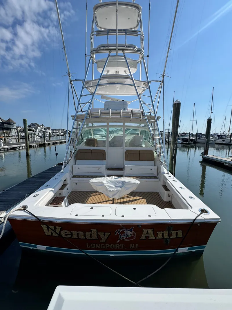 Slide: The Image of 2021 Albemarle 41 Express boat docked, rear view, clear sky, marina setting. - 15