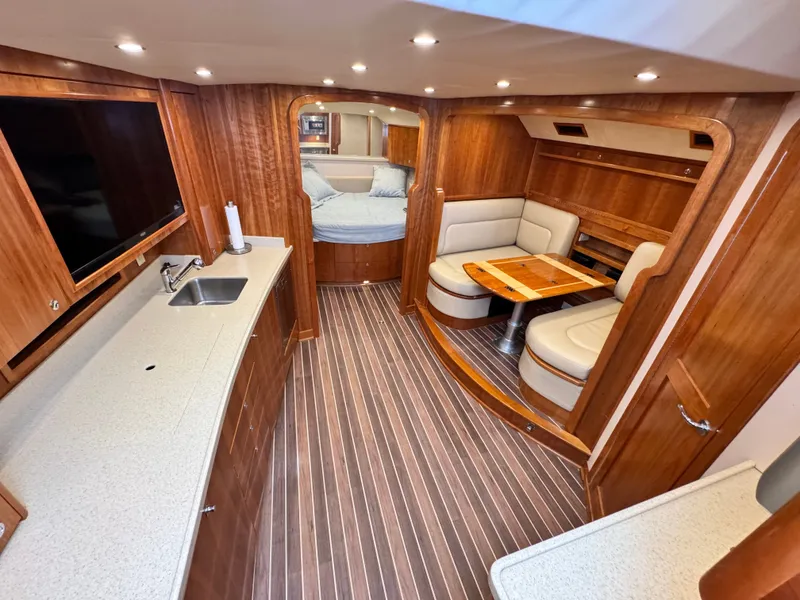 Slide: The Image of Luxurious interior of 2021 Albemarle 41 Express yacht with wood finish and cozy seating area. - 16