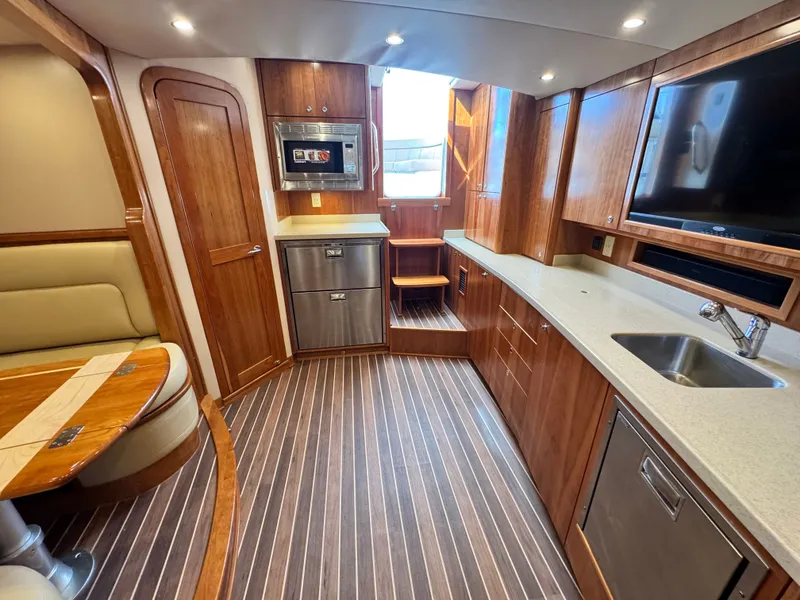 Slide: The Image of Luxurious interior of 2021 Albemarle 41 Express yacht with modern kitchen and seating area. - 17