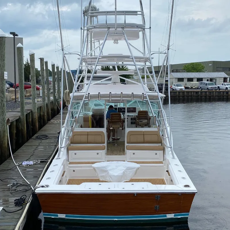 Slide: The Image of 2021 Albemarle 41 Express yacht docked at marina, featuring spacious seating and fishing tower. - 2