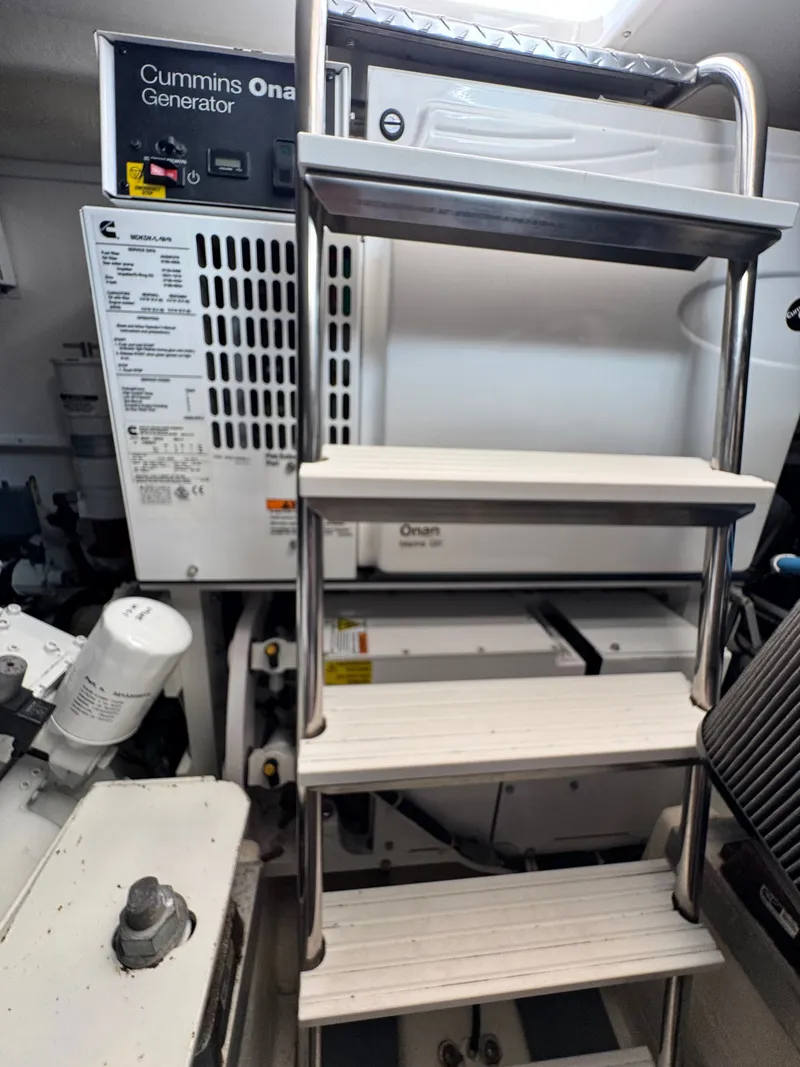 Slide: The Image of Engine room of 2021 Albemarle 41 Express with Cummins Onan generator and ladder. - 24