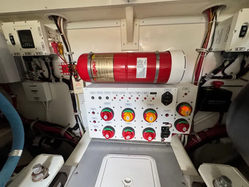 Slide: The Image of Engine room of 2021 Albemarle 41 Express with control panel and fire extinguisher. - 27