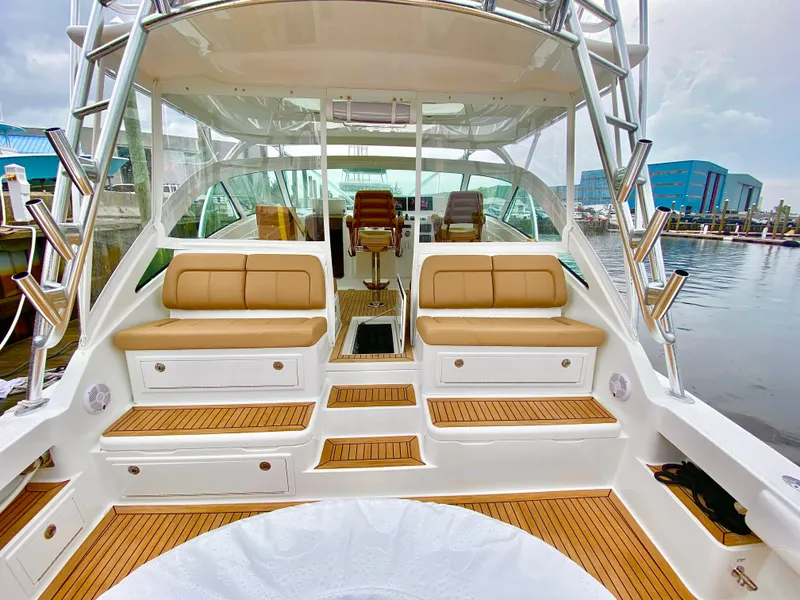 Slide: The Image of 2021 Albemarle 41 Express yacht interior with tan seating and wooden flooring. - 3