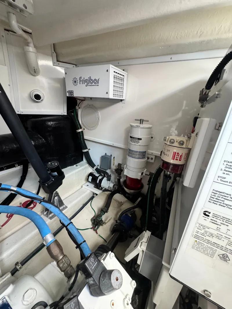 Slide: The Image of Engine room of 2021 Albemarle 41 Express boat with Frigibar unit and various components. - 30
