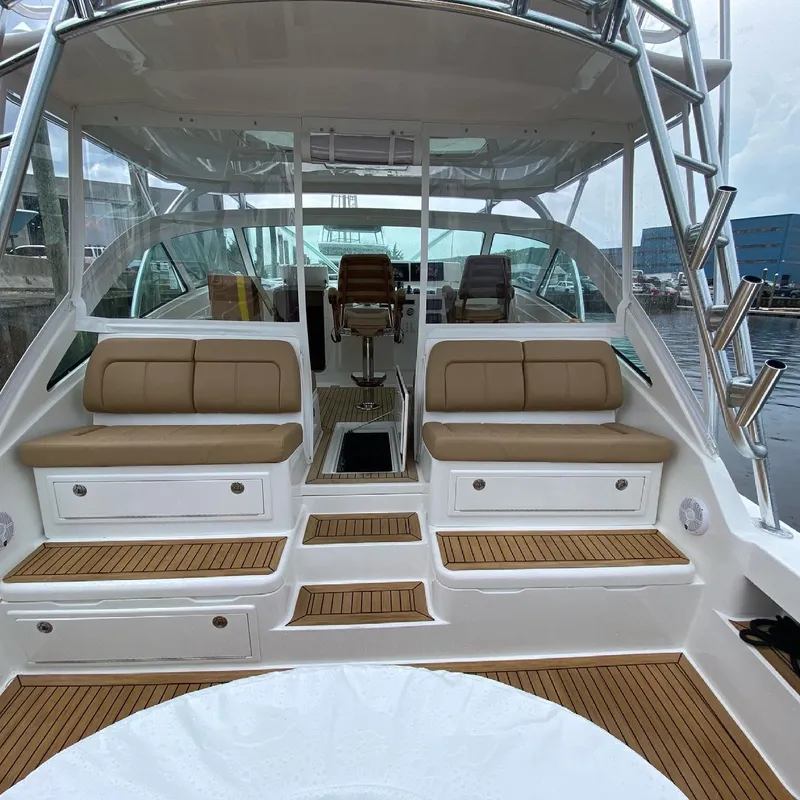 Slide: The Image of 2021 Albemarle 41 Express yacht interior with tan seating and wooden flooring. - 4