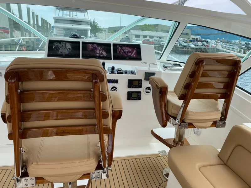 Slide: The Image of 2021 Albemarle 41 Express helm with leather seats and advanced navigation displays. - 5