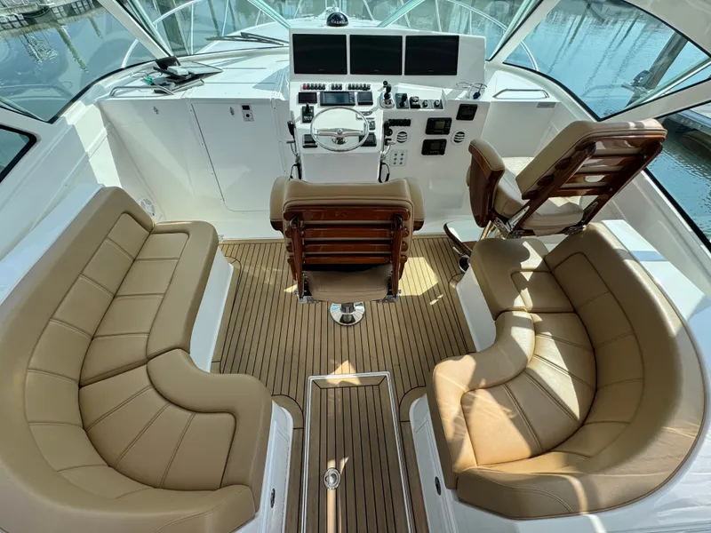 Slide: The Image of 2021 Albemarle 41 Express yacht interior with helm, leather seating, and wood flooring. - 6