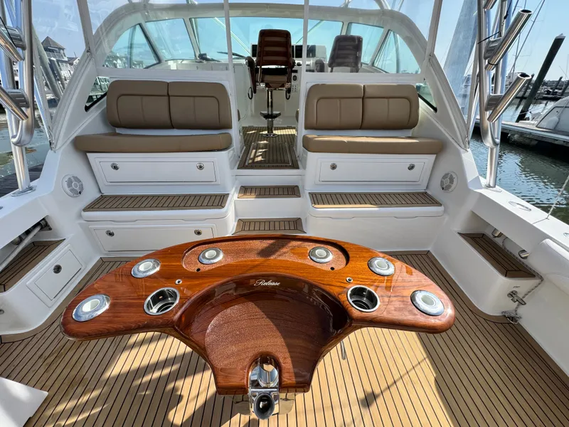 Slide: The Image of 2021 Albemarle 41 Express boat interior with teak flooring and cushioned seating. - 8