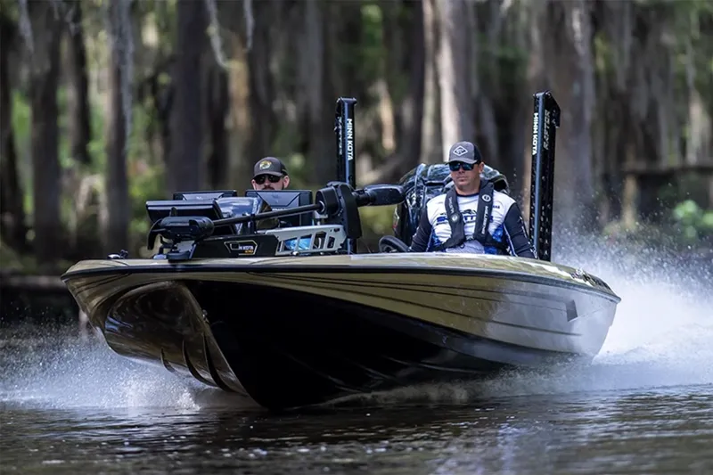 Slide: The Image of Manufacturer Provided Image: 2026 Skeeter FXR21 Apex boat speeding on a forested waterway. - 14