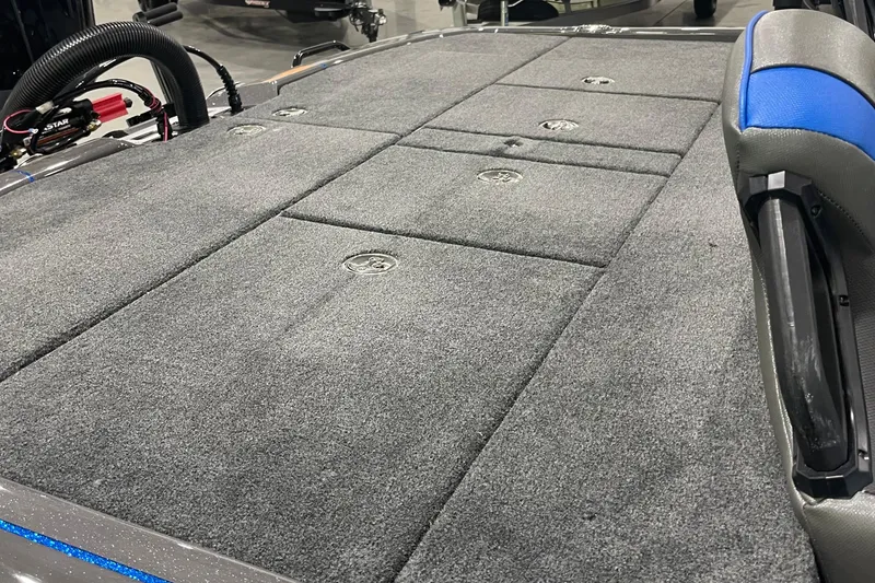 Slide: The Image of 2026 Skeeter FXR21 Apex boat deck with gray carpet and storage compartments. - 5