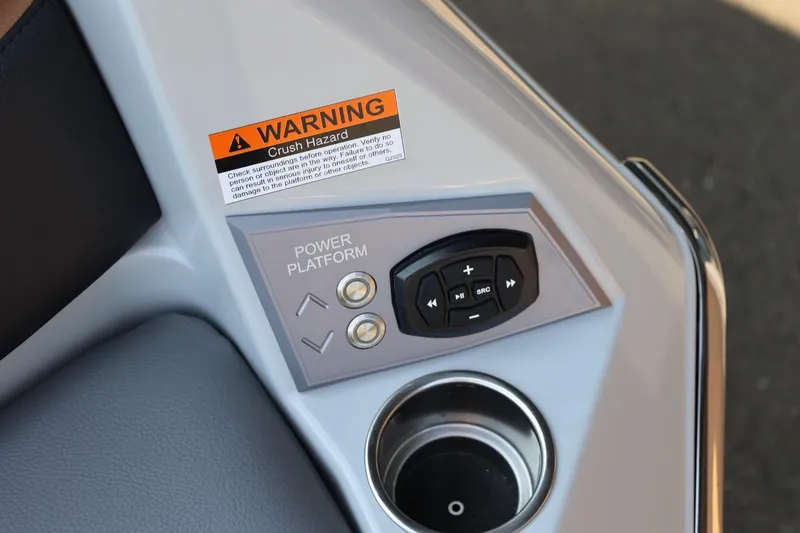 Slide: The Image of Control panel of 2026 Tigé Ultré 25ZX boat with warning label and cup holder. - 16
