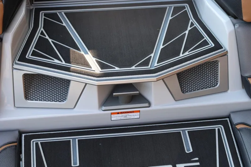 Slide: The Image of 2026 Tigé Ultré 25ZX boat interior with geometric design and textured flooring. - 17