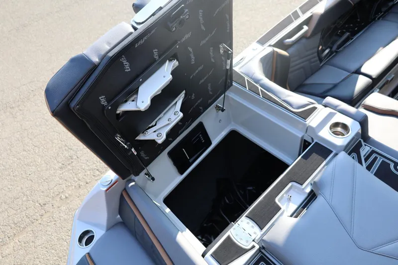 Slide: The Image of 2026 Tigé Ultré 25ZX boat interior storage compartment with open seat and cup holder. - 23