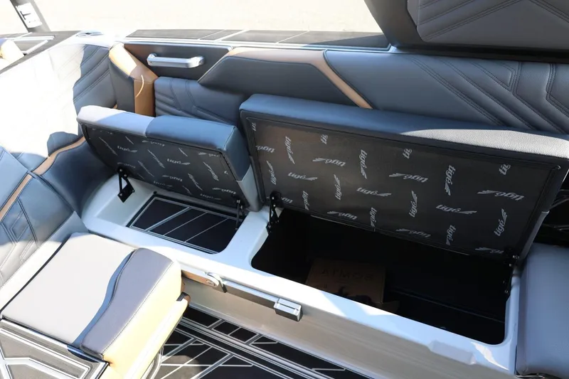 Slide: The Image of 2026 Tigé Ultré 25ZX boat interior with open storage compartments and luxurious seating. - 32