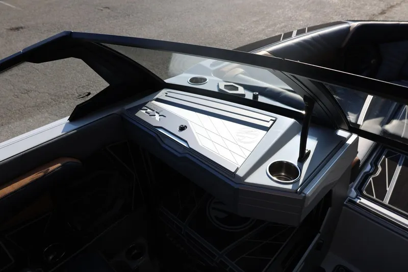 Slide: The Image of 2026 Tigé Ultré 25ZX boat interior with sleek dashboard and cup holders. - 39