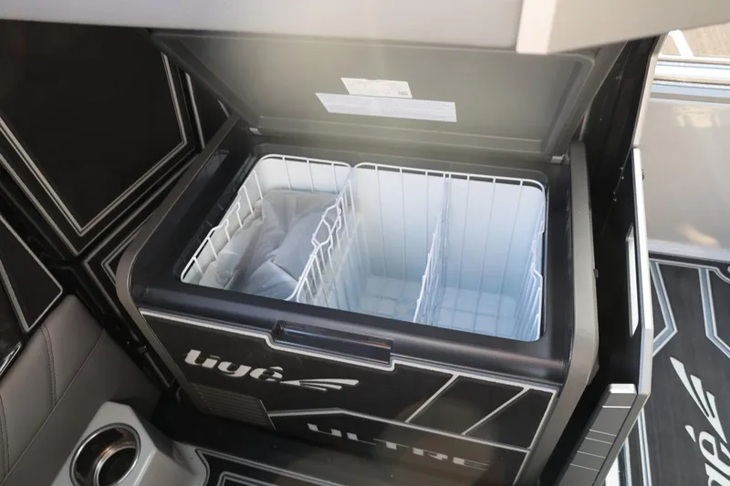 Slide: The Image of Open storage compartment in 2026 Tigé Ultré 25ZX boat interior. - 41