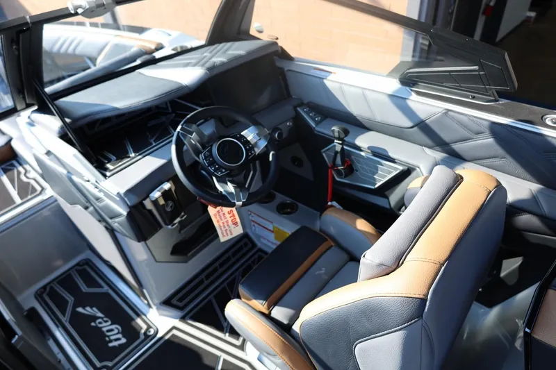 Slide: The Image of 2026 Tigé Ultré 25ZX boat interior with modern steering and seating design. - 42