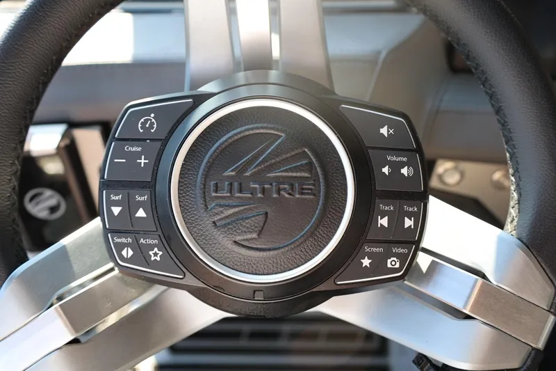 Slide: The Image of Steering wheel controls of 2026 Tigé Ultré 25ZX boat, featuring cruise and audio functions. - 45