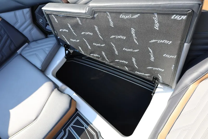 Slide: The Image of 2026 Tigé Ultré 25ZX boat interior storage compartment with branded upholstery. - 58