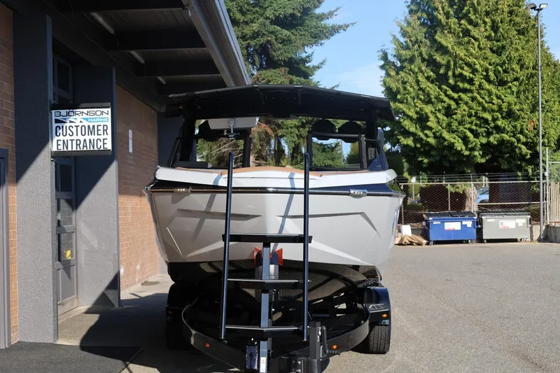 Slide: The Image of 2026 Tigé Ultré 25ZX boat on trailer outside Bjornson Marine customer entrance. - 68