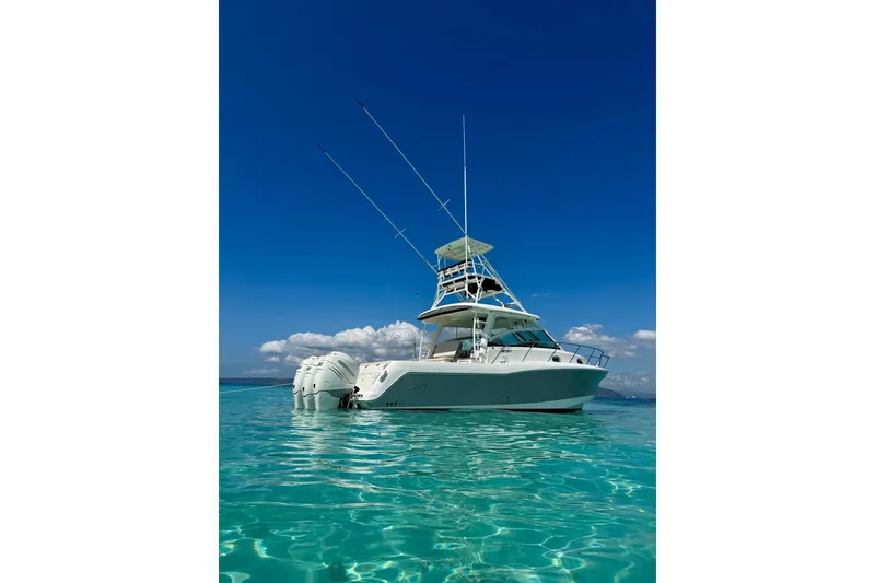 Slide: The Image of 2018 Boston Whaler 345 Conquest boat on clear turquoise water under blue sky. - 5