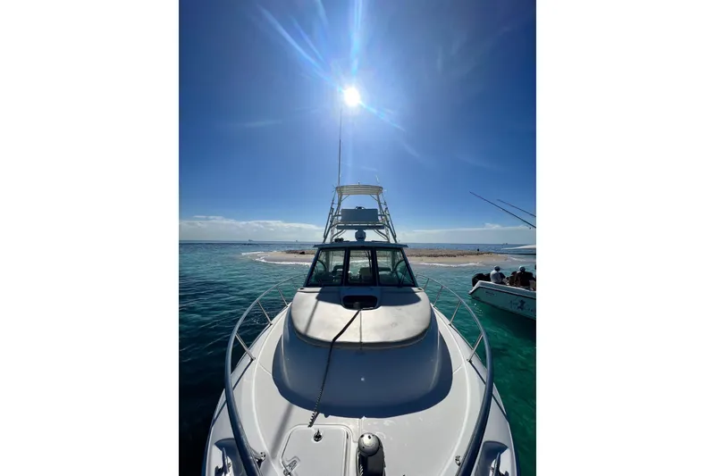 Slide: The Image of 2018 Boston Whaler 345 Conquest on clear blue water under bright sun. - 6