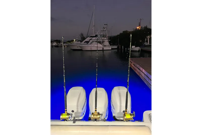 Slide: The Image of Boston Whaler 345 Conquest 2018 with fishing rods and illuminated water at night. - 7