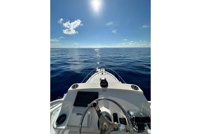 Slide: The Image of 2018 Boston Whaler 345 Conquest navigating open sea under clear blue sky. - 9