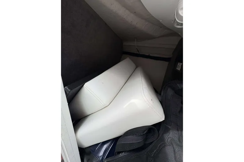 Slide: The Image of 2017 Monterey 298SS boat interior storage with white cushions and dark fabric lining. - 19