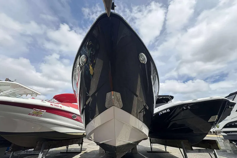 Slide: The Image of 2017 Monterey 298SS boat on display under a cloudy sky. - 2