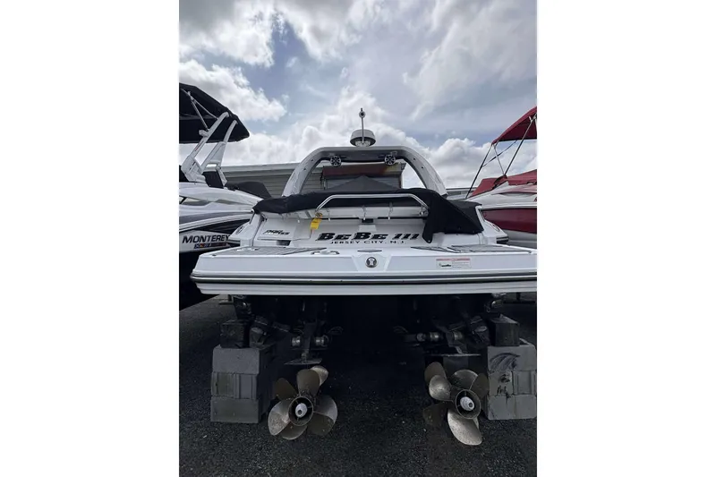 Slide: The Image of 2017 Monterey 298SS boat with dual propellers, parked under a cloudy sky. - 26