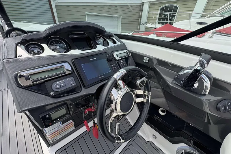 Slide: The Image of Cockpit of 2017 Monterey 298SS boat with modern controls and steering wheel. - 6