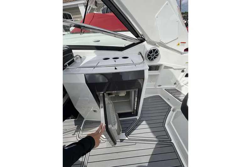 Slide: The Image of 2017 Monterey 298SS boat interior with open mini fridge and sleek design. - 8