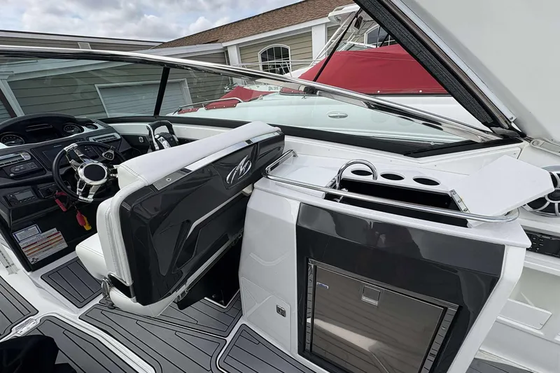 Slide: The Image of 2017 Monterey 298SS boat interior with sleek dashboard and modern amenities. - 9