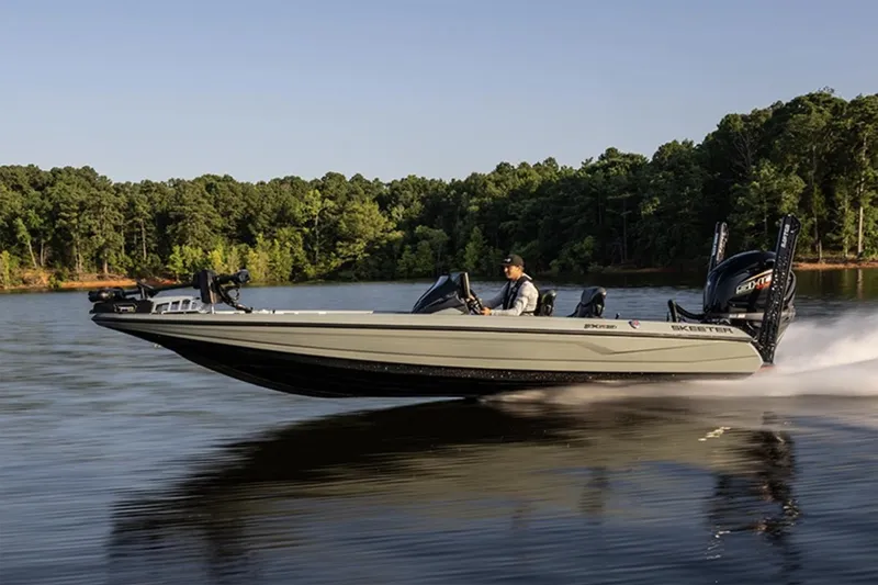 Slide: The Image of Manufacturer Provided Image: 2026 Skeeter FXR20 Apex boat speeding on a lake with forested shoreline. - 6