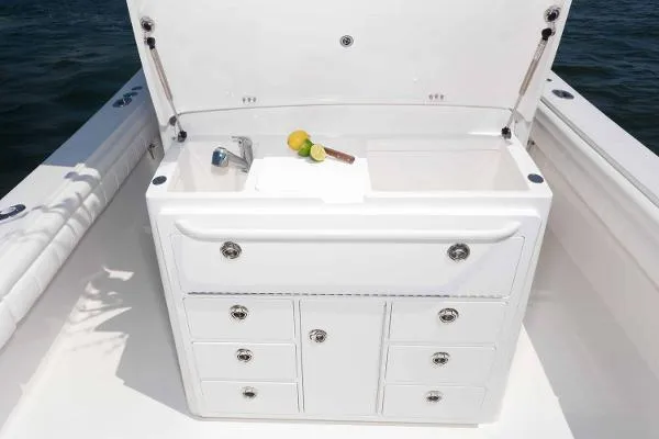 Slide: The Image of 2021 Regulator 34 Center Console boat with open storage compartment and sink. - 10