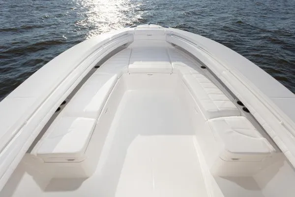 Slide: The Image of 2021 Regulator 34 Center Console boat interior with white seating, on calm water. - 13