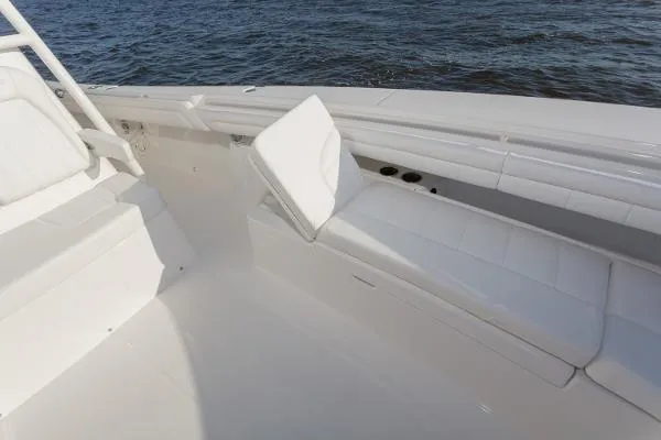 Slide: The Image of 2021 Regulator 34 Center Console boat interior with white seating by the water. - 14