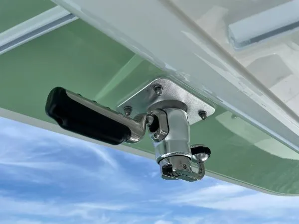 Slide: The Image of 2021 Regulator 34 Center Console boat detail with a metal handle against a blue sky. - 20