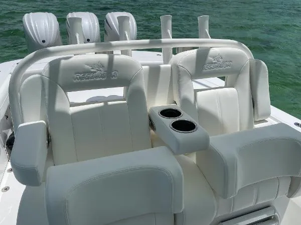 Slide: The Image of 2021 Regulator 34 Center Console boat with white seating and cup holders on the deck. - 22