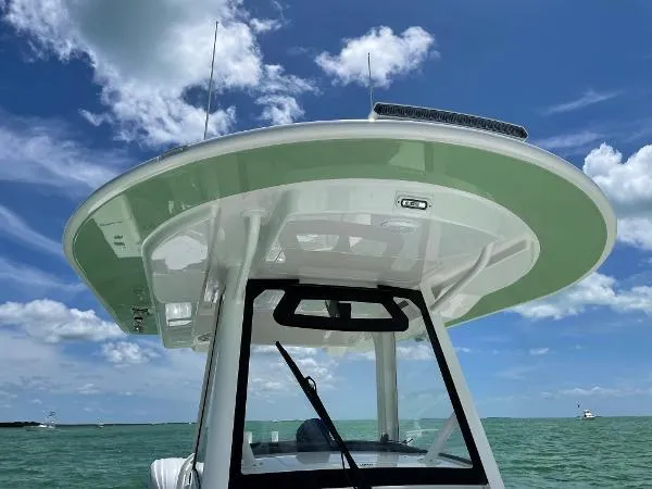Slide: The Image of 2021 Regulator 34 Center Console boat on open water under blue sky. - 23