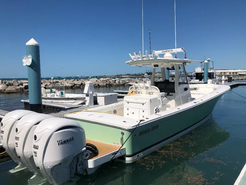Slide: The Image of 2021 Regulator 34 Center Console boat docked with twin Yamaha engines. - 4